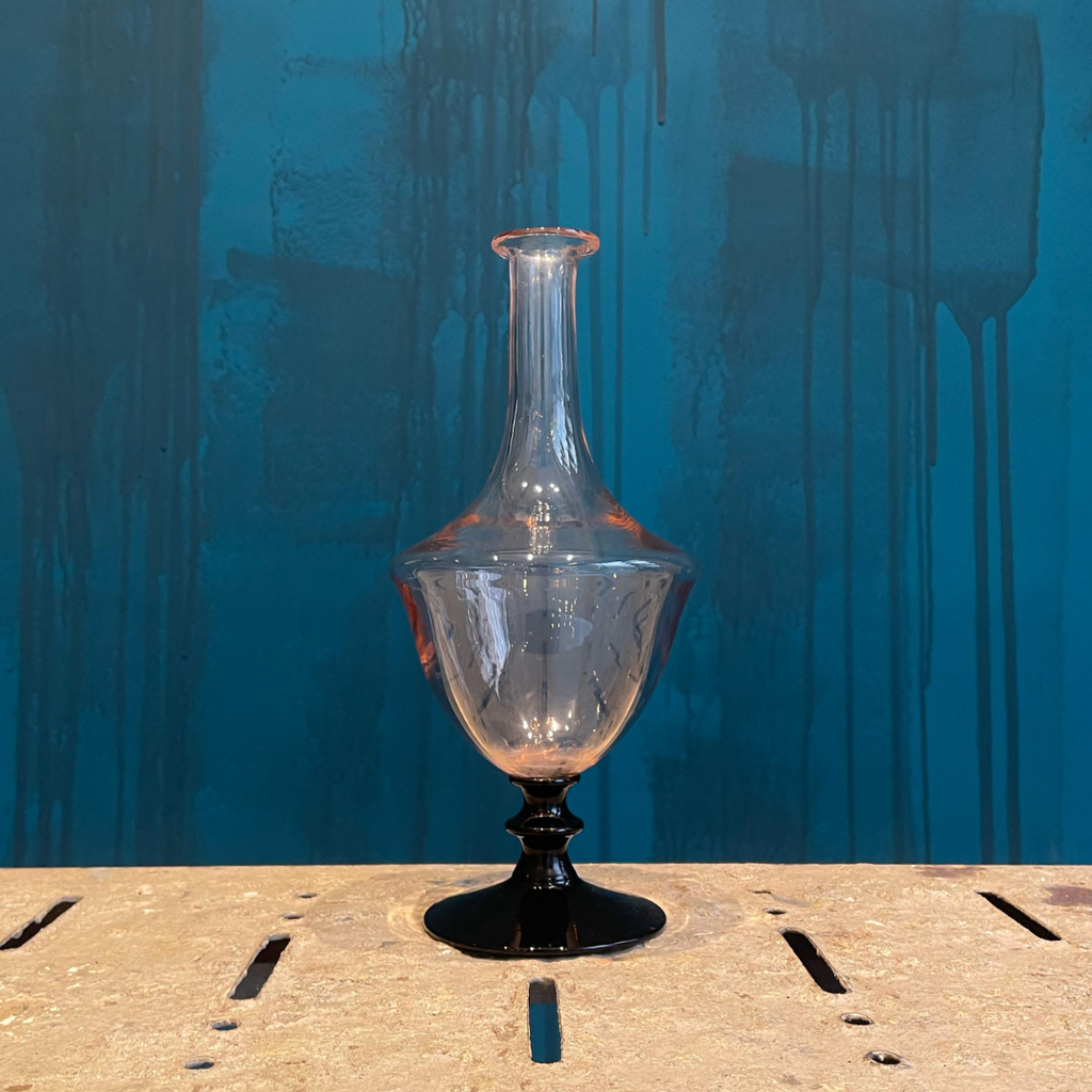 Jarrón Vintage vidrio rosa con base negra.